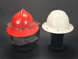 pair of white and red hard hats sitting on top of a black table