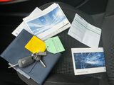a car seat with a bunch of papers and keys on it