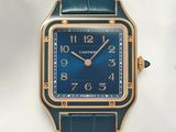 an image of a watch with a blue dial on a green strap