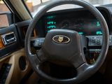 a steering wheel and dashboard of a car with a clock on it