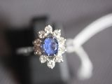 a close up of a ring with a tan and blue stone