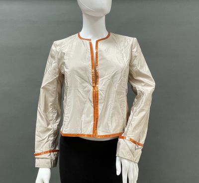 an image of a mannequin mannequin wearing a gold jacket and black skirt