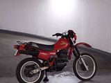a red motorcycle parked in a parking garage