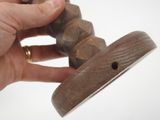 a person holding a wooden object in their hand