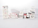 several boxes of medical supplies sitting on top of a white surface
