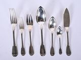 five spoons and six forks on a white surface