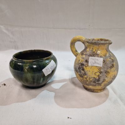 two vases sitting next to each other on a table