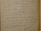 an old book with a handwritten letter on it sitting on top of a table