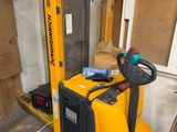 a yellow fork lift truck parked in a garage