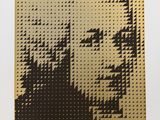 a gold and black painting of a woman ' s face on a white background