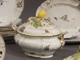 a lot of plates and bowls that are sitting on a table