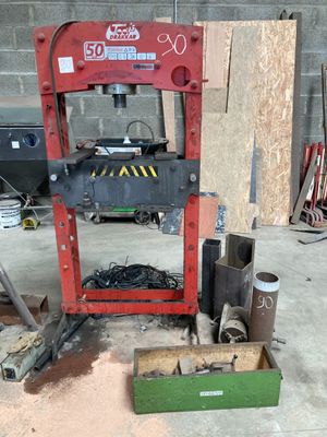 a red machine that is sitting in a garage