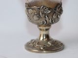 a silver cup that is sitting on a table
