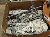 a cardboard box filled with assorted metal parts