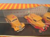 three toy cars that are in a box on a table