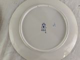 a white plate with blue writing on it sitting on a table