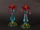pair of colorful glass candlesticks on a black background