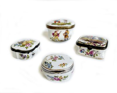 several different types of decorative boxes are arranged on a white surface