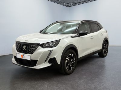 a white car is parked in a large room with a black floor