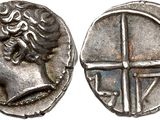 a silver coin with an image of a woman on it