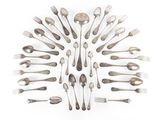 a lot of spoons and forks arranged in the shape of a circle