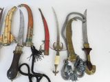 many different types of knives hanging on a wall