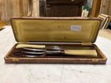 a knife and fork in a case on a table