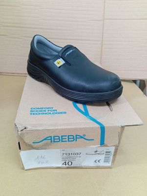 a blue shoe on top of a box on a table