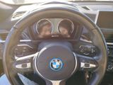 two young children sitting in the driver ' s seat of a car