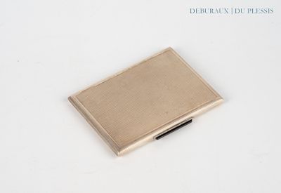 a small metal box with a pen in it on a white surface