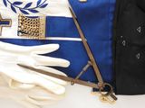 a blue and white uniform with a cross and a pair of white gloves