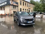 a grey car parked in front of a building on a rainy day
