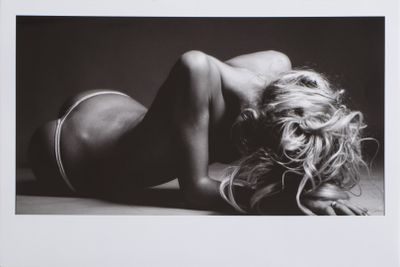 black and white photograph of a woman laying on the floor