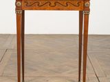 a small wooden table with a marble top on a parquet floor