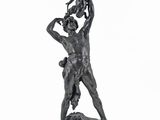 statue of a man holding a child on his shoulders