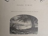 an old book with a black and white image of a river