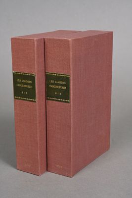 two pink books sitting on top of each other on a gray surface