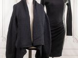 two mannequins in front of a white wall and a black dress on a mannequin stand