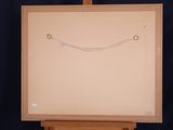 drawing of a smiling face on an easel against a black background