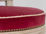 a close up of a chair with a red cushion on it