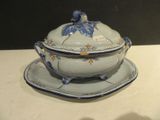a blue and white bowl and saucer on a white table