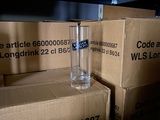 many boxes and a glass of water sitting on a shelf