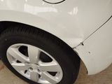 a close up of a white car with a broken tire