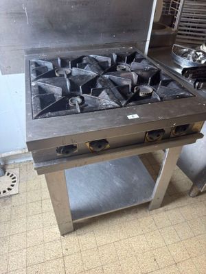 a stove that is sitting in the middle of a kitchen