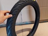 a person that is holding a tire in their hand