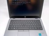 laptop with a program on the screen sitting on a white surface