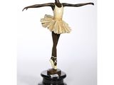 a statue of a woman in a tutu is standing on a pedestal