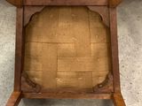 the back of a chair with a seat made out of wood