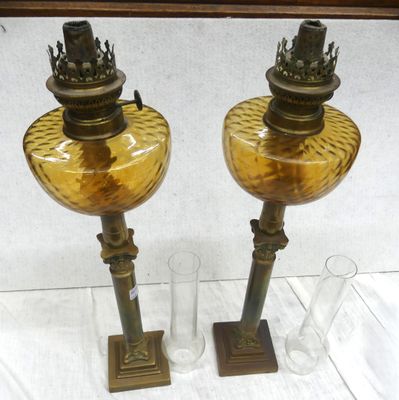 two glass vases sitting on a table next to each other