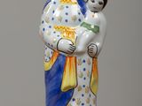 a statue of a woman holding a child on a table